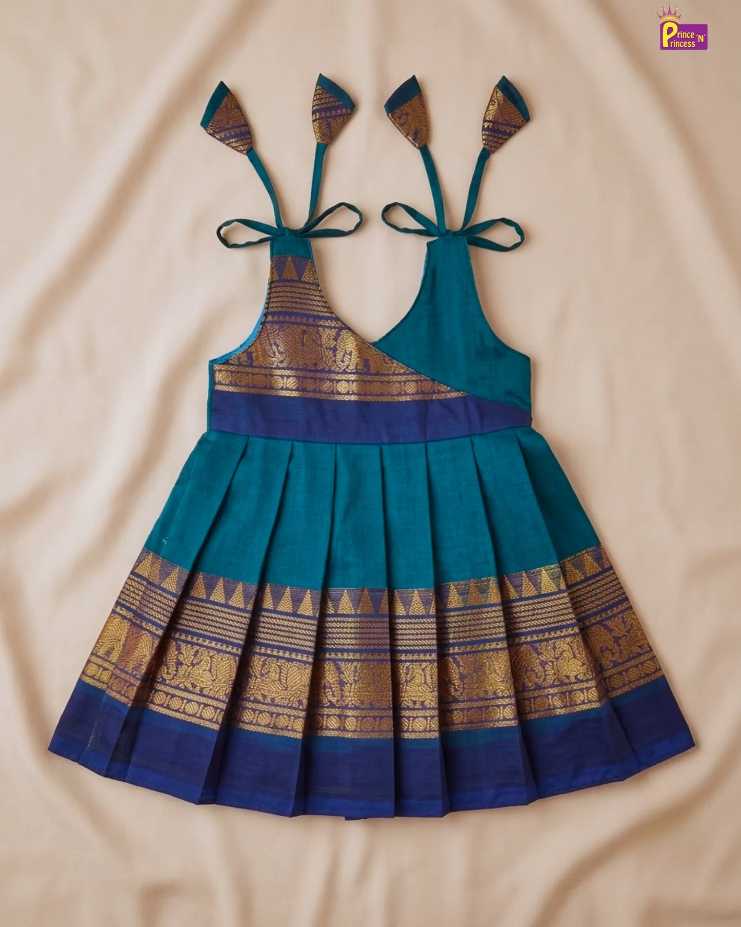 Traditional blue and gold dress with intricate patterns on a beige background