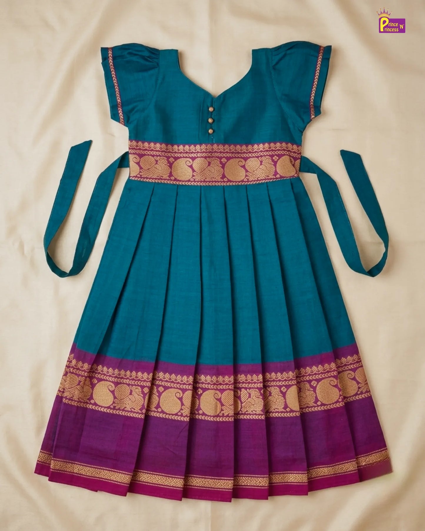 Teal and purple traditional dress with gold patterns on a beige background