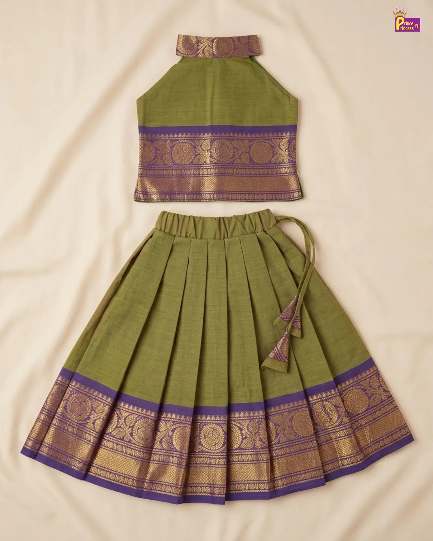 Green traditional outfit with purple and gold patterns on a beige background