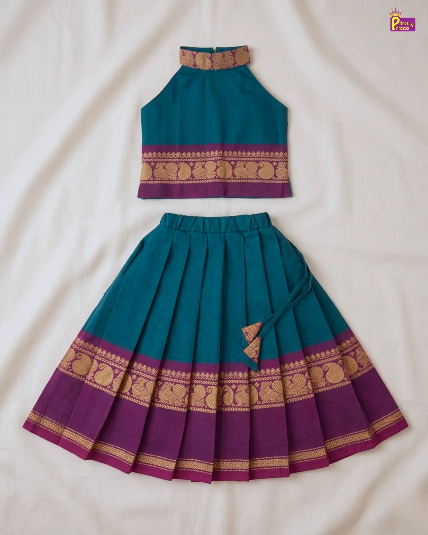 Teal and purple traditional outfit with decorative patterns on a white background