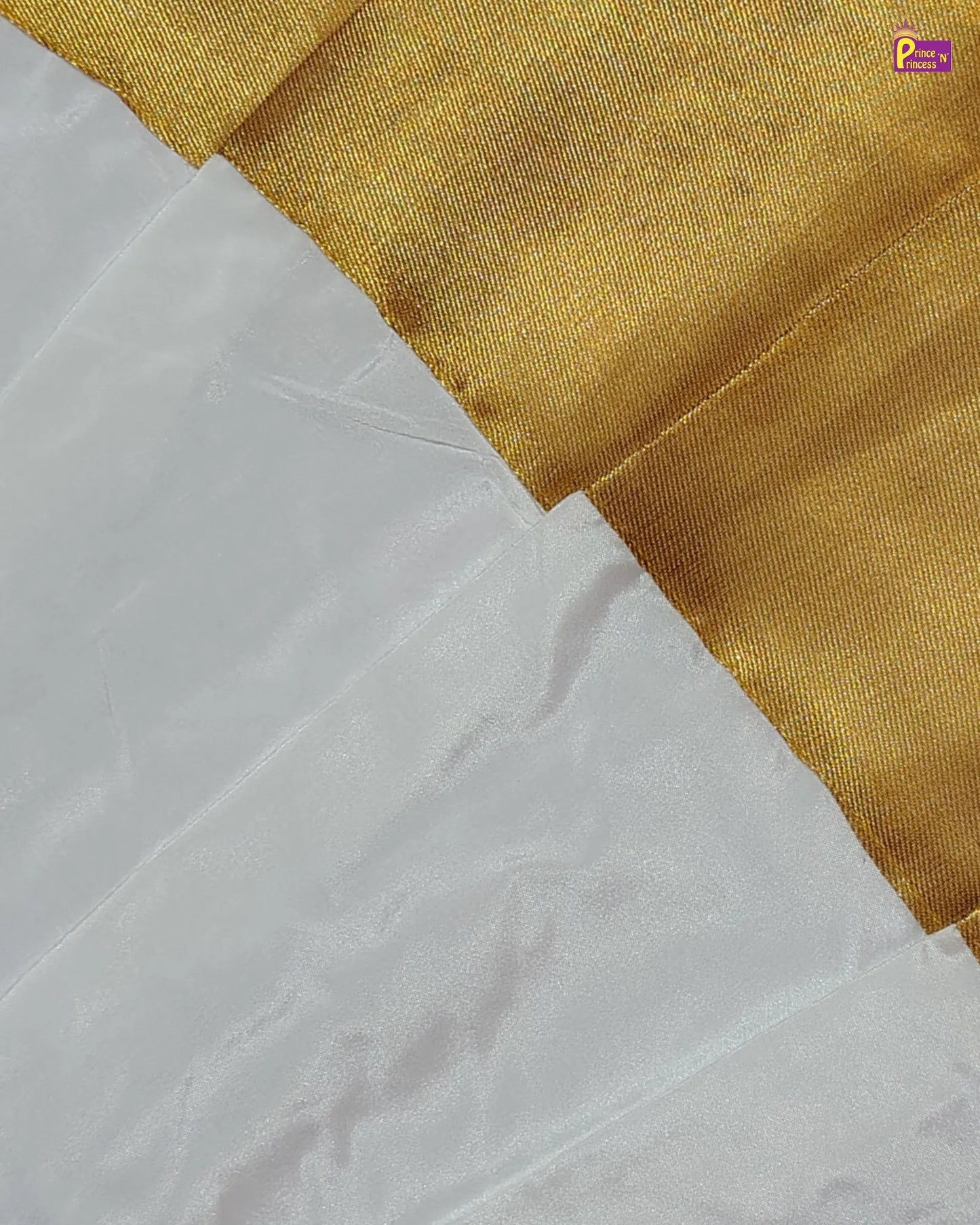 Close-up of white fabric with a gold border