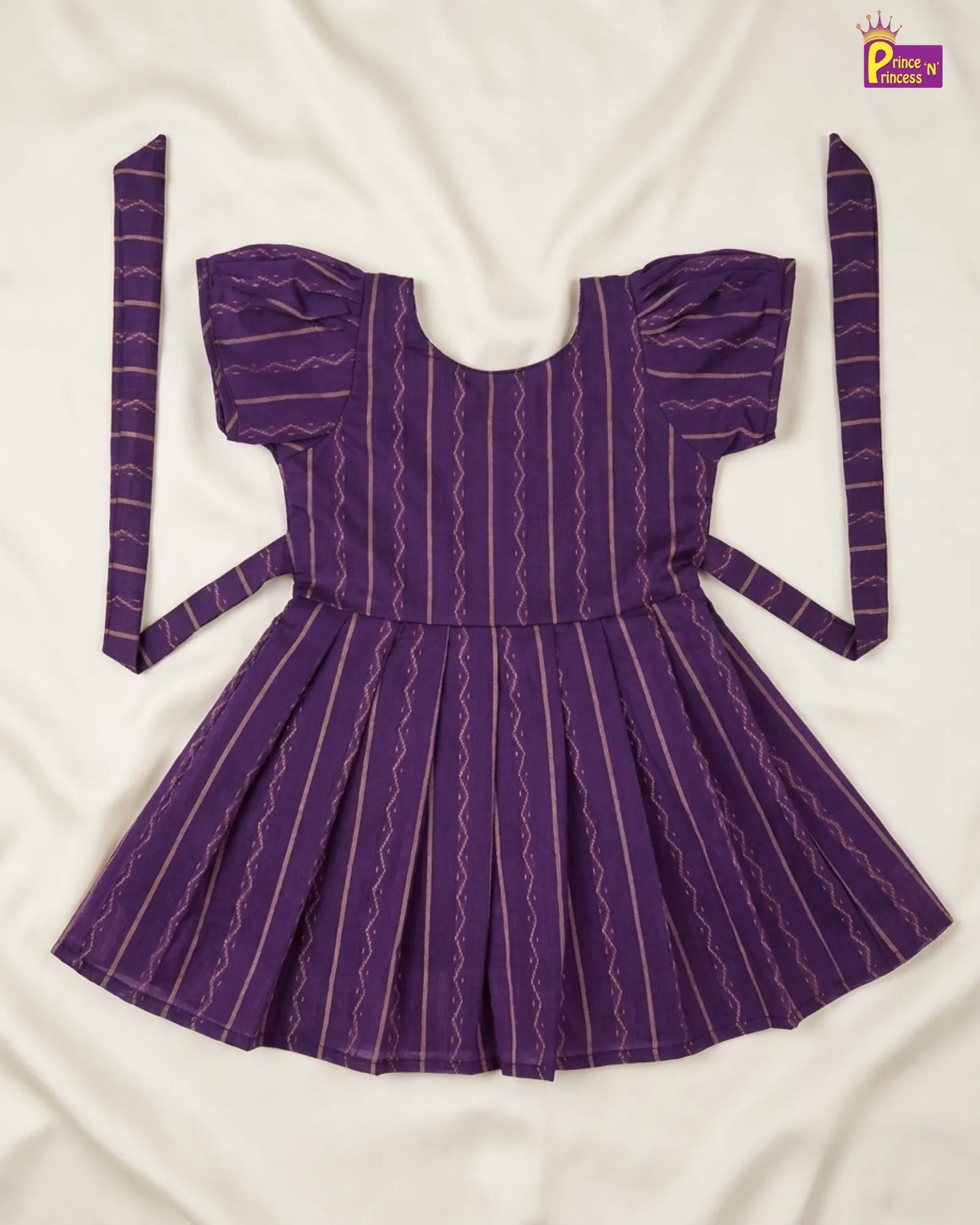 Purple dress with puffed sleeves and a belt on a white background
