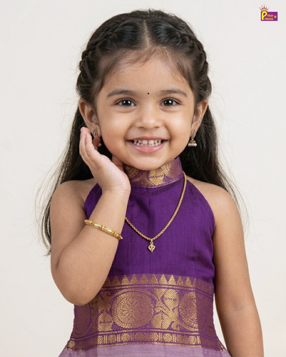 Young girl in a purple traditional outfit with gold accents on a white background
