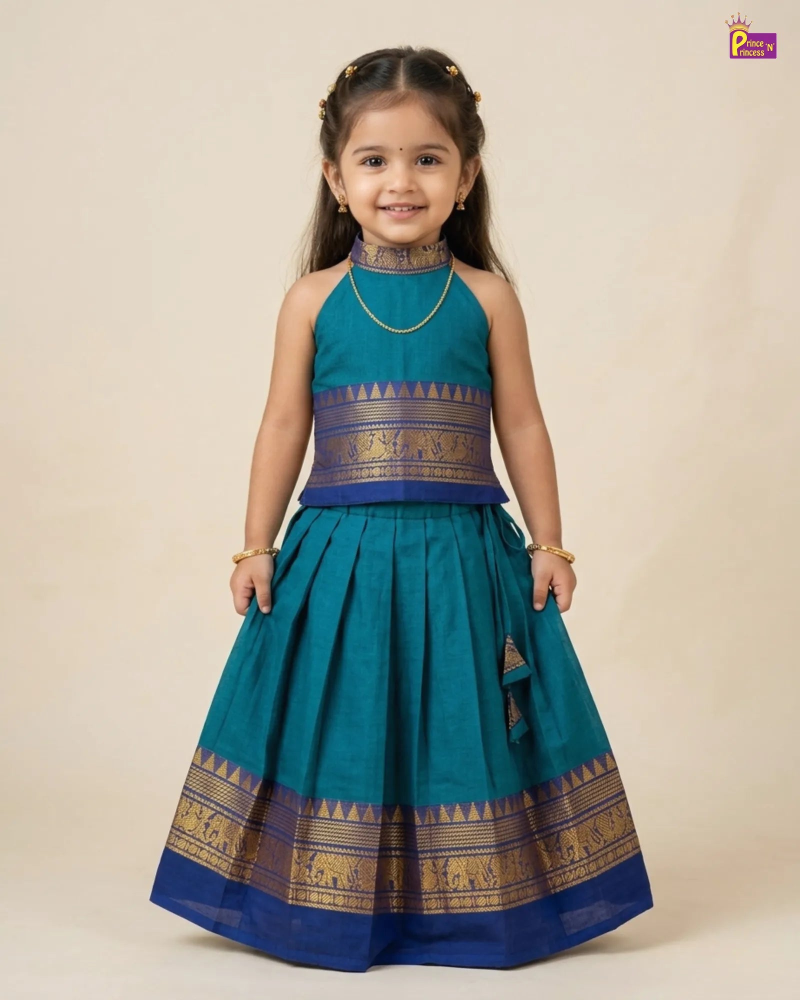 Young girl wearing a traditional teal and blue outfit with gold accents on a beige background