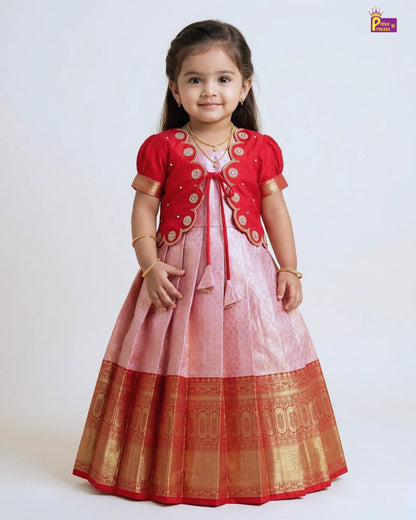 Young girl wearing a traditional outfit with a red and gold jacket over a pink dress on a white background.
