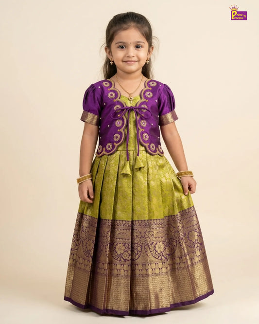 Young girl wearing a traditional outfit with a purple top and green skirt on a beige background