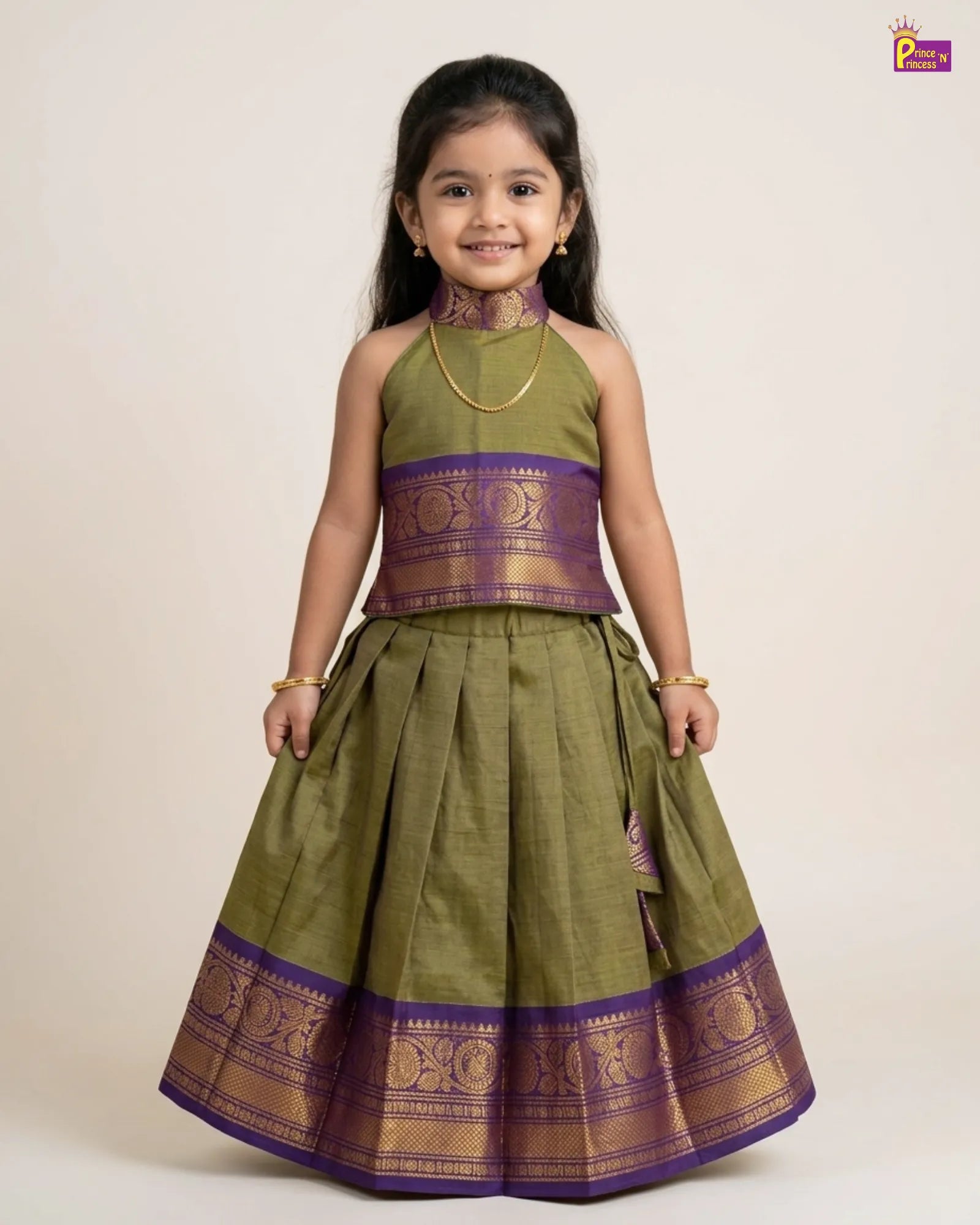 Young girl wearing a green and purple traditional outfit on a beige background