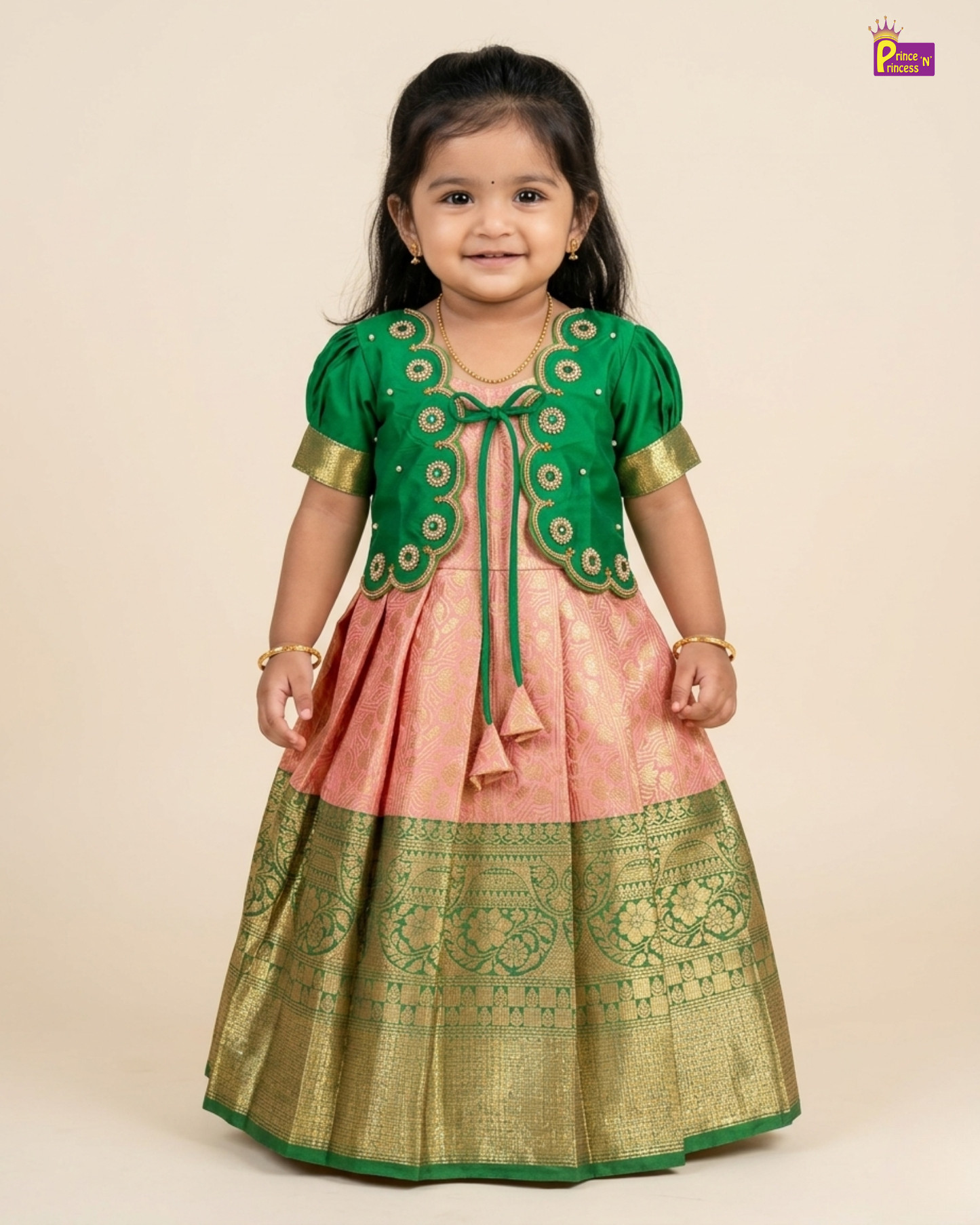 Child wearing a traditional outfit with green and pink colors on a beige background