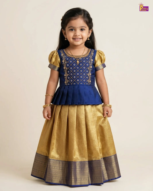 Young girl wearing a blue and gold traditional outfit on a beige background