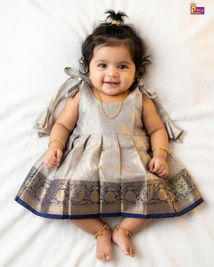 Baby wearing a traditional outfit with decorative elements on a white background