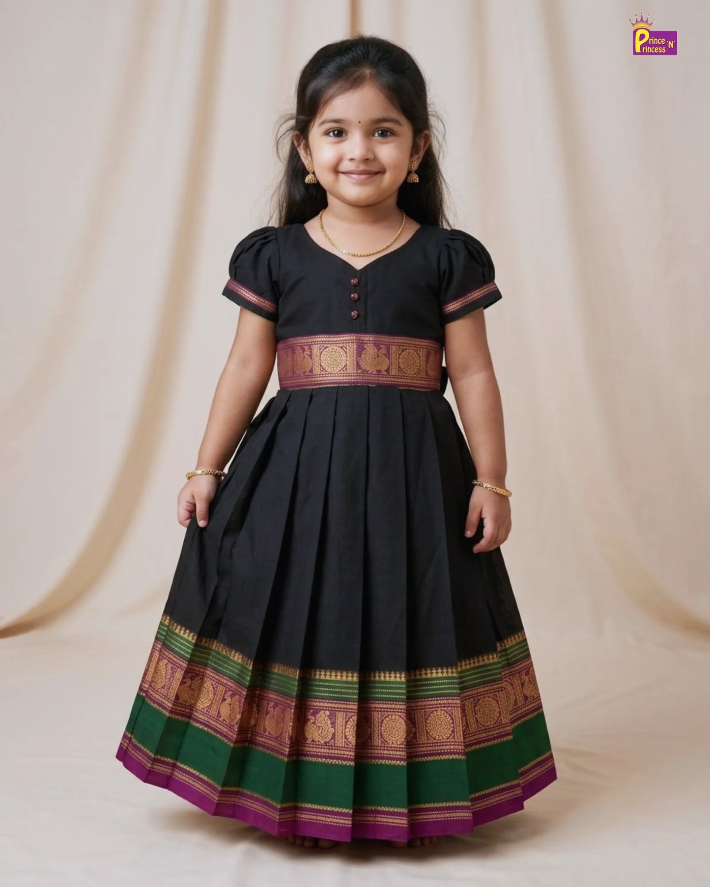 Young girl wearing a black traditional dress with colorful patterns on a beige background