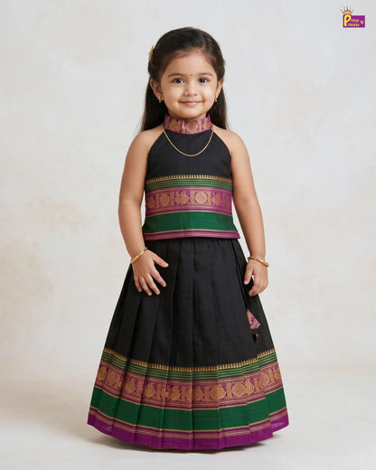 Young girl wearing a traditional outfit with a black skirt and colorful top on a white background