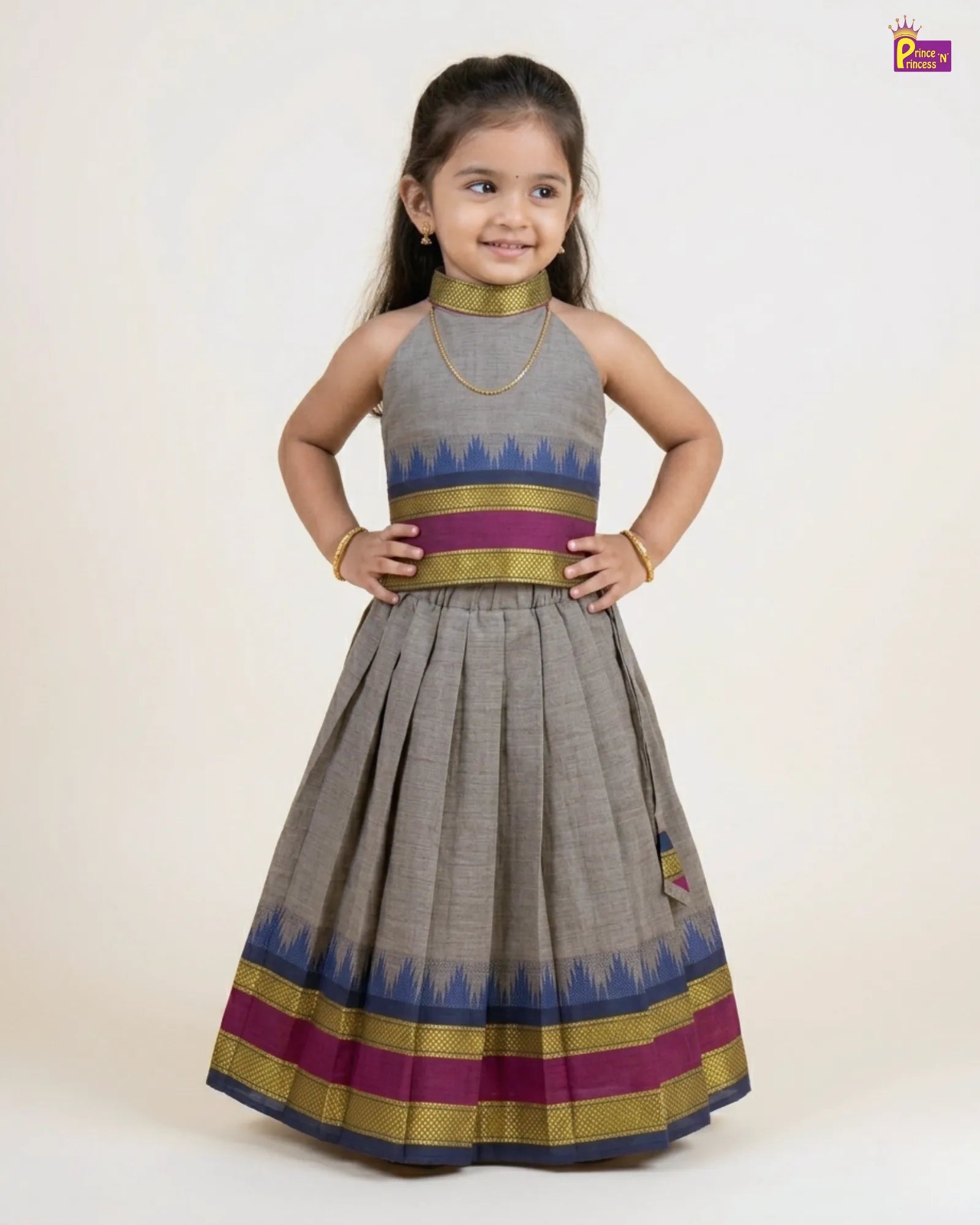 Young girl wearing a traditional outfit with a gray dress and colorful patterns on a white background