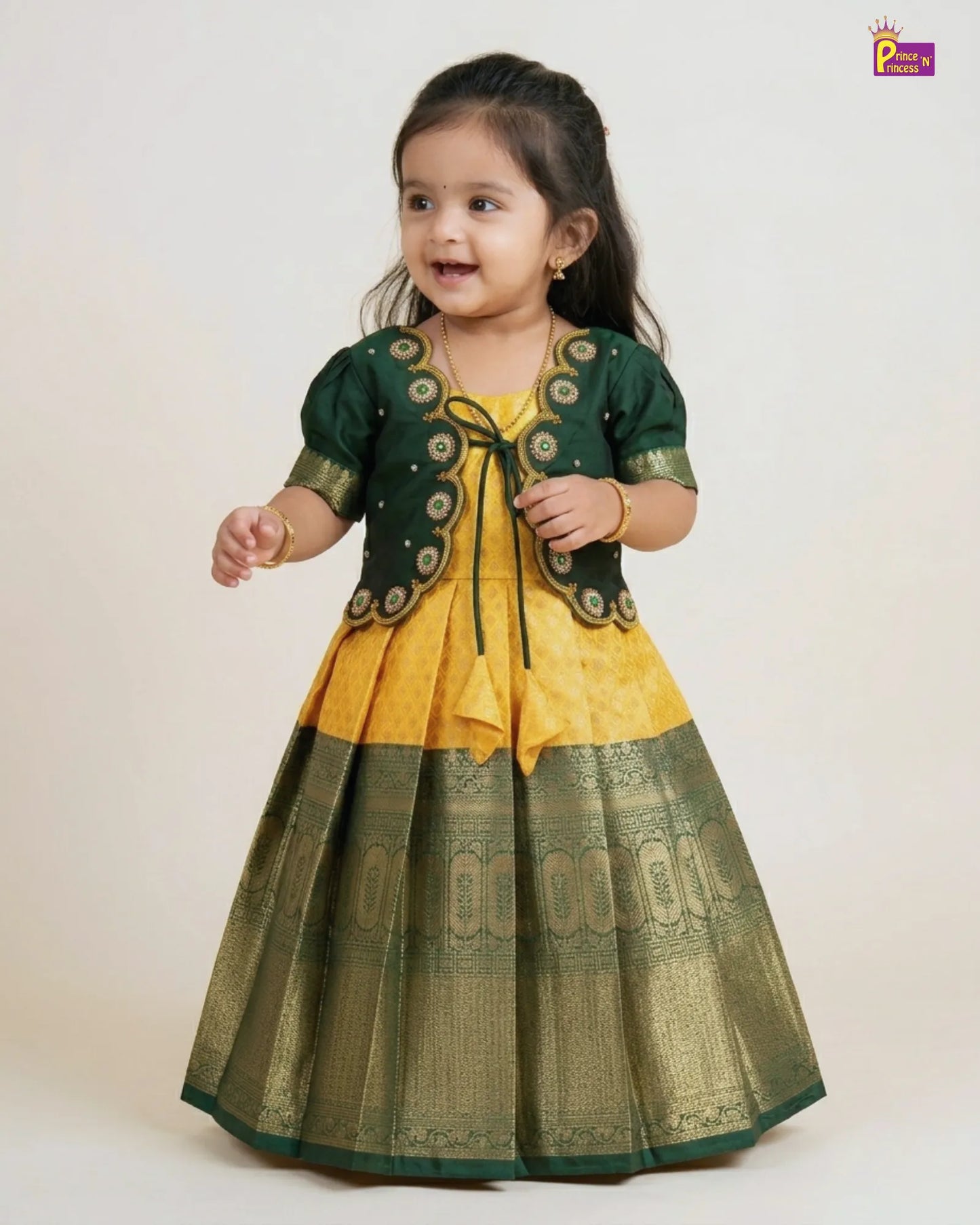 Child wearing a yellow and green traditional outfit on a white background