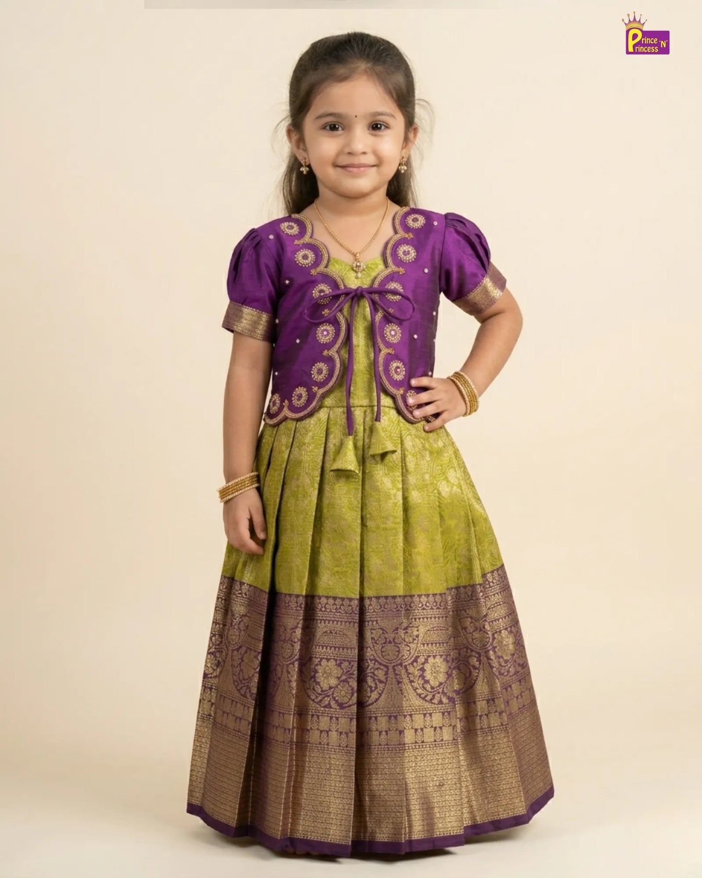 Young girl wearing a traditional outfit with a purple top and green skirt on a beige background