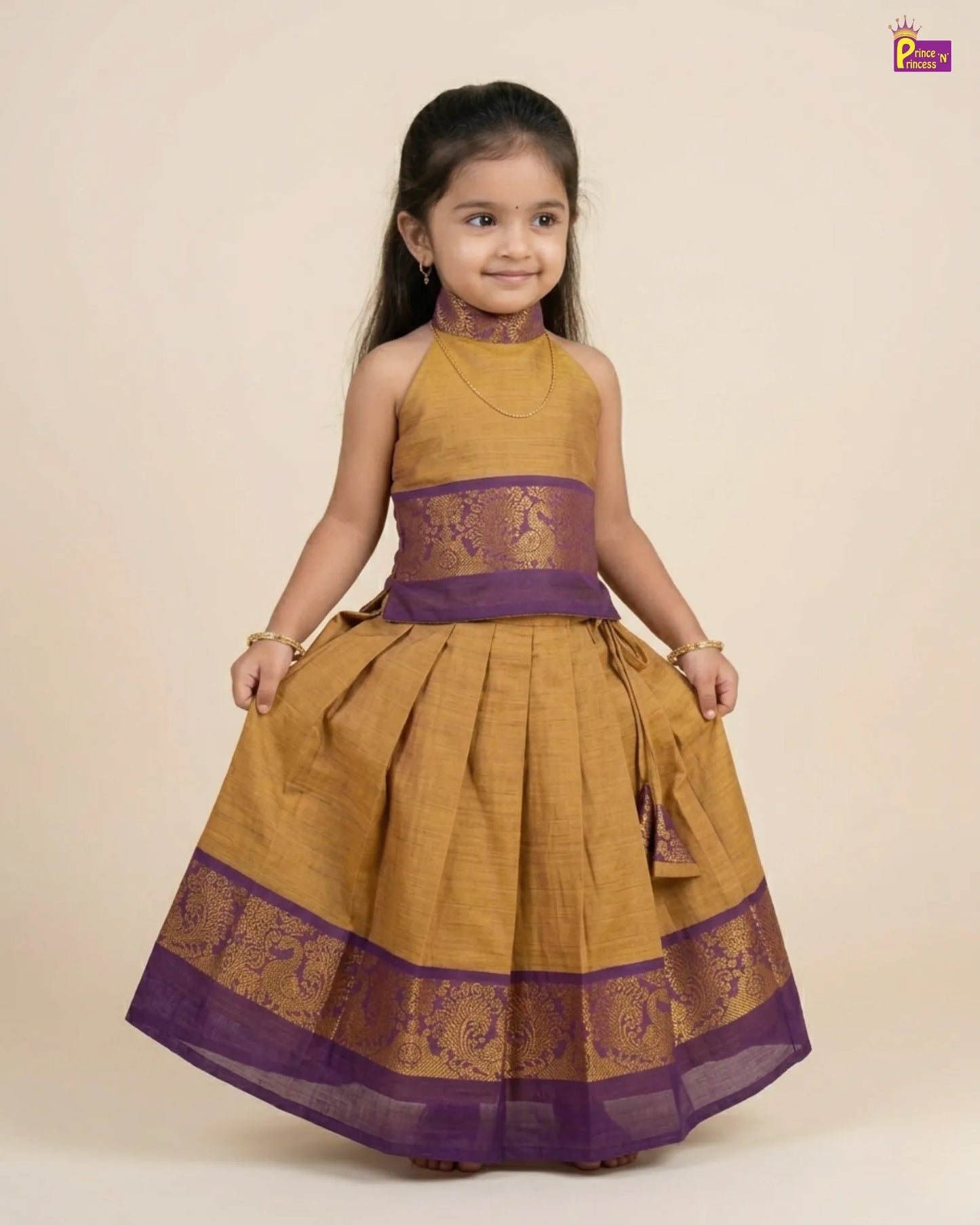 Young girl wearing a mustard yellow and purple traditional outfit on a beige background