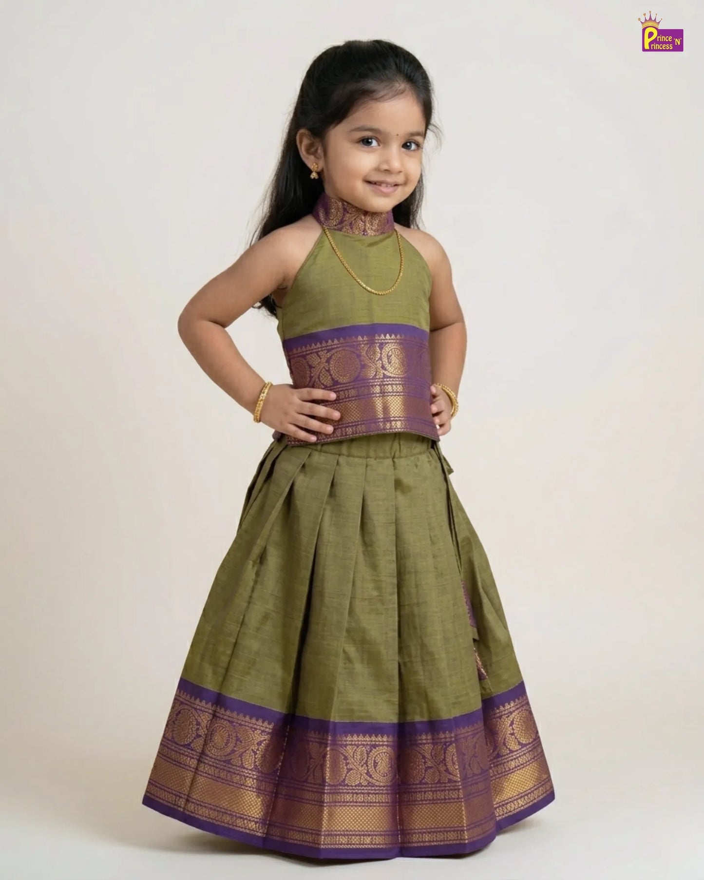 Young girl wearing a green and purple traditional outfit on a white background