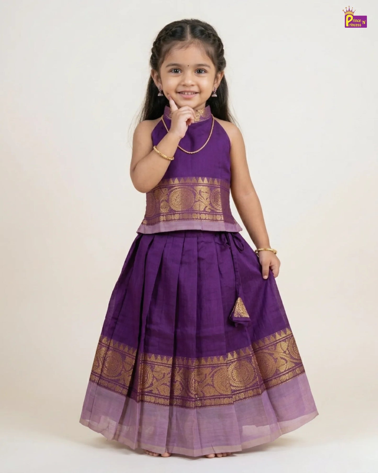 Young girl wearing a purple traditional outfit with gold patterns on a white background