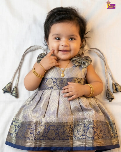 Baby in a traditional outfit with decorative elements on a white background