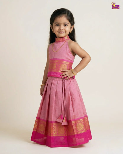 Young girl wearing a pink traditional outfit with gold accents on a white background