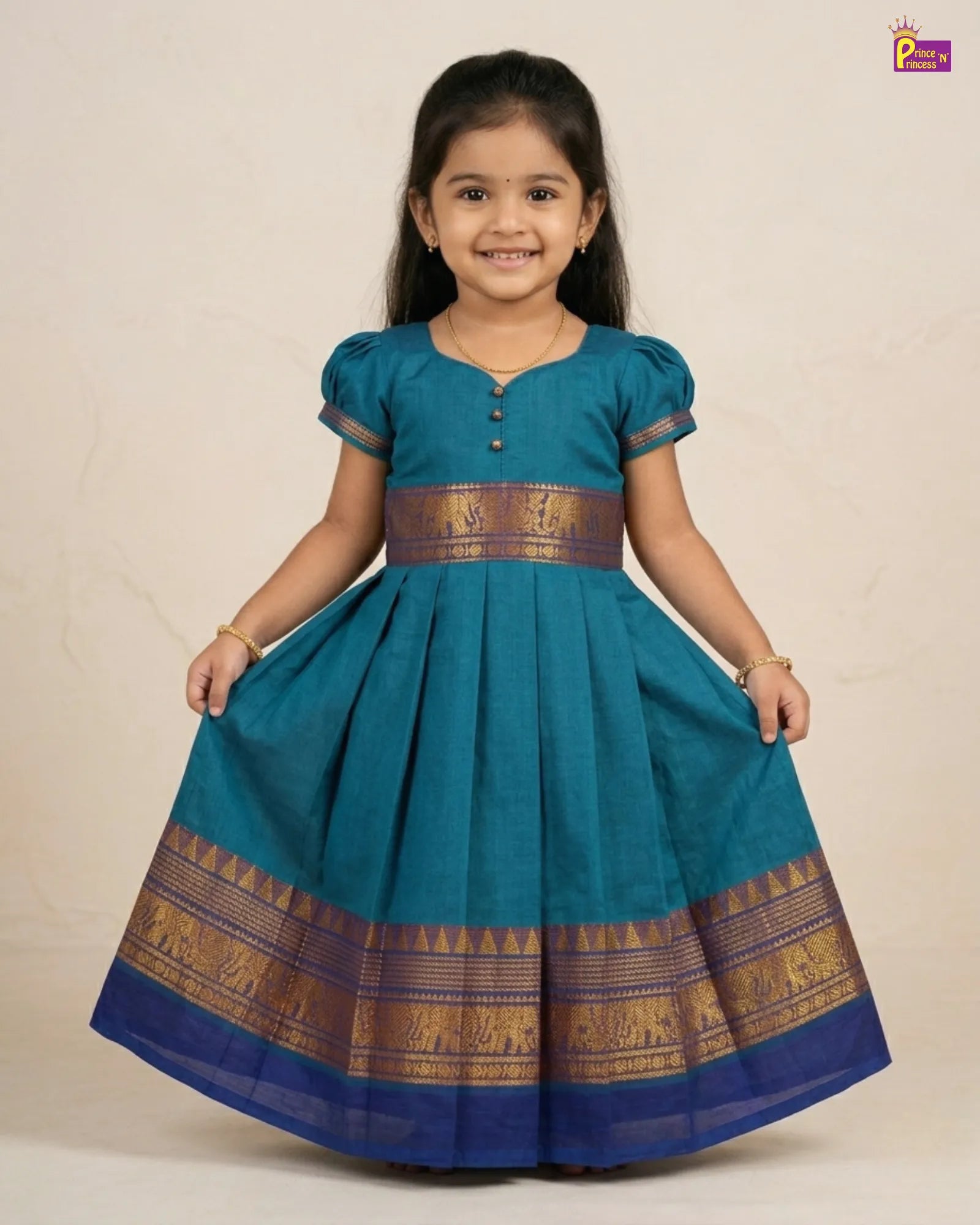 Young girl wearing a blue traditional dress with gold patterns on a beige background