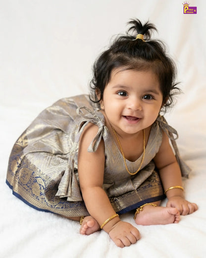 Baby in traditional outfit with gold jewelry on a white background