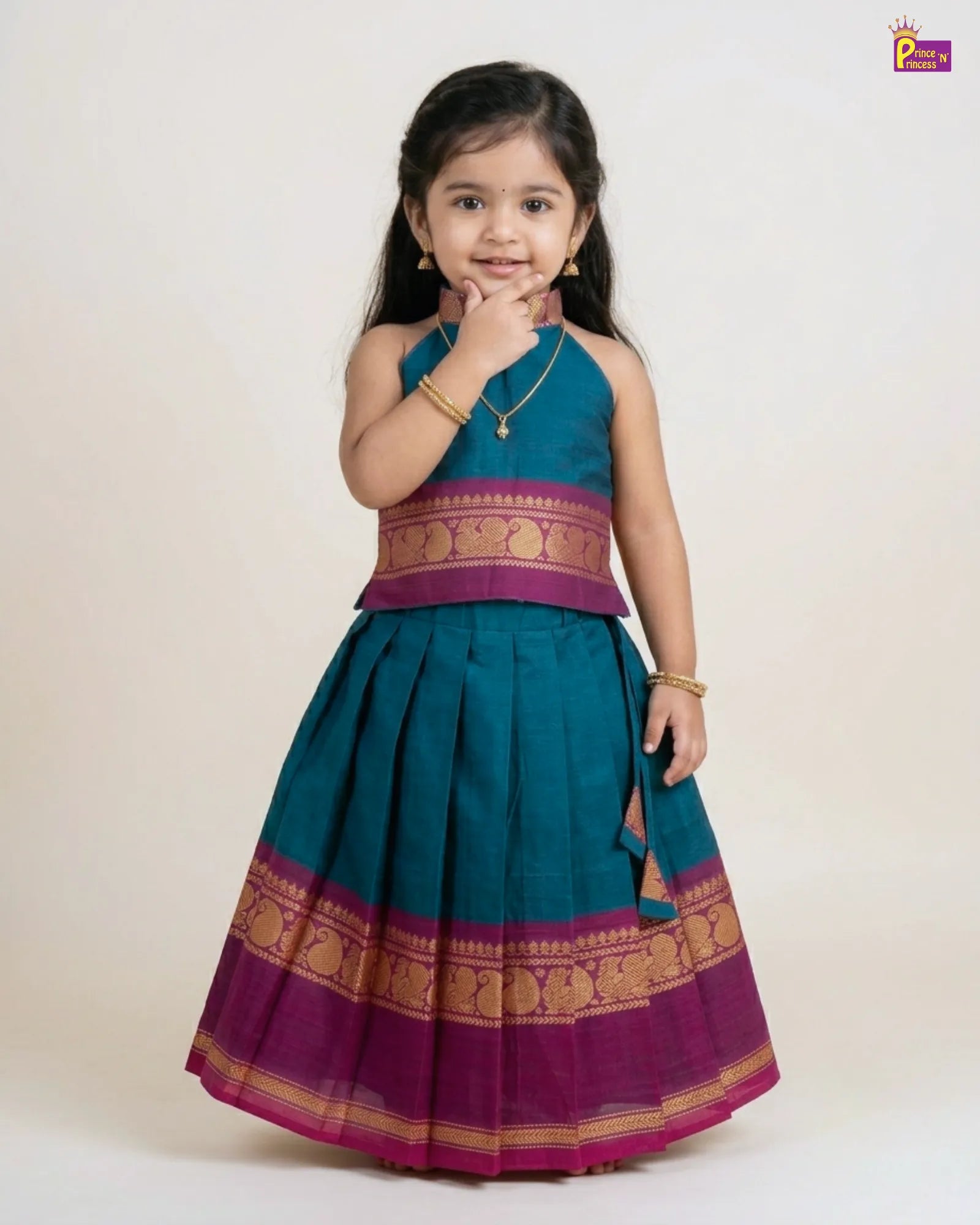 Young girl wearing a traditional outfit with a green and purple dress on a white background