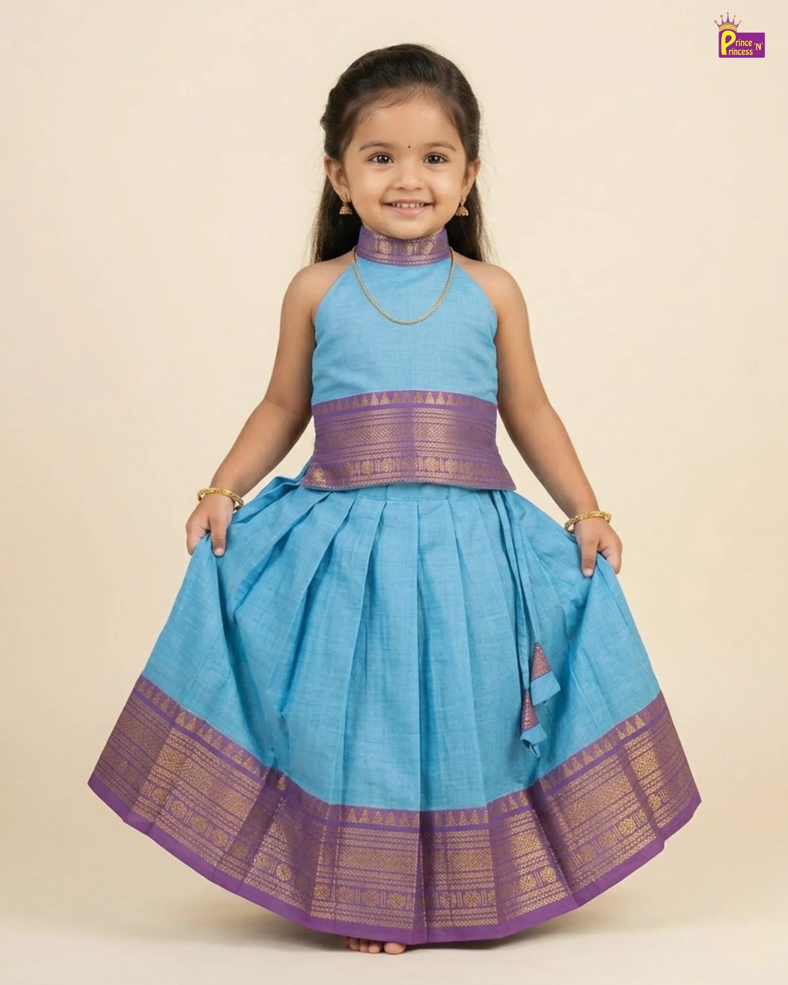 Young girl wearing a blue and purple traditional outfit on a beige background