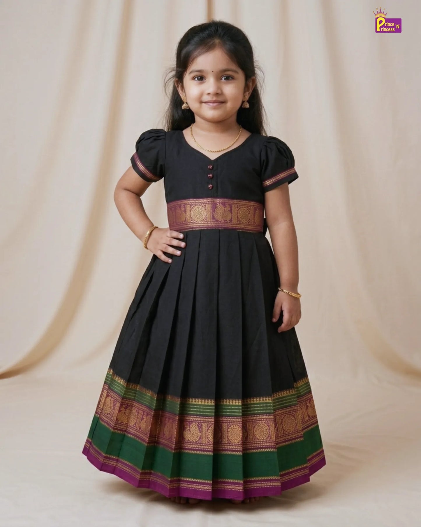 Young girl wearing a black traditional dress with colorful patterns on a beige background