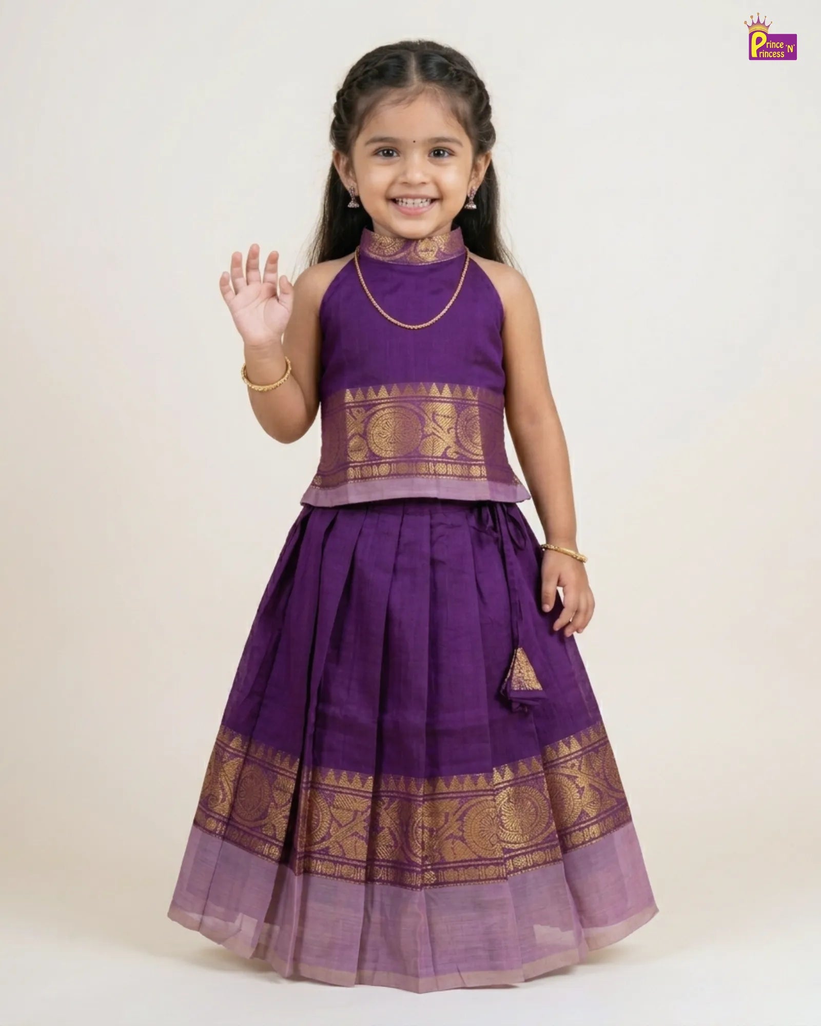 Young girl wearing a purple traditional outfit with gold patterns on a white background