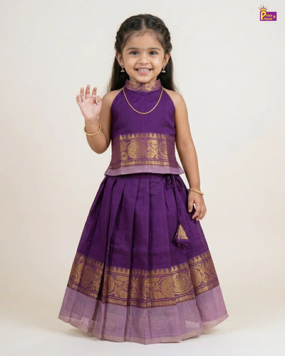 Young girl wearing a purple traditional outfit with gold patterns on a white background