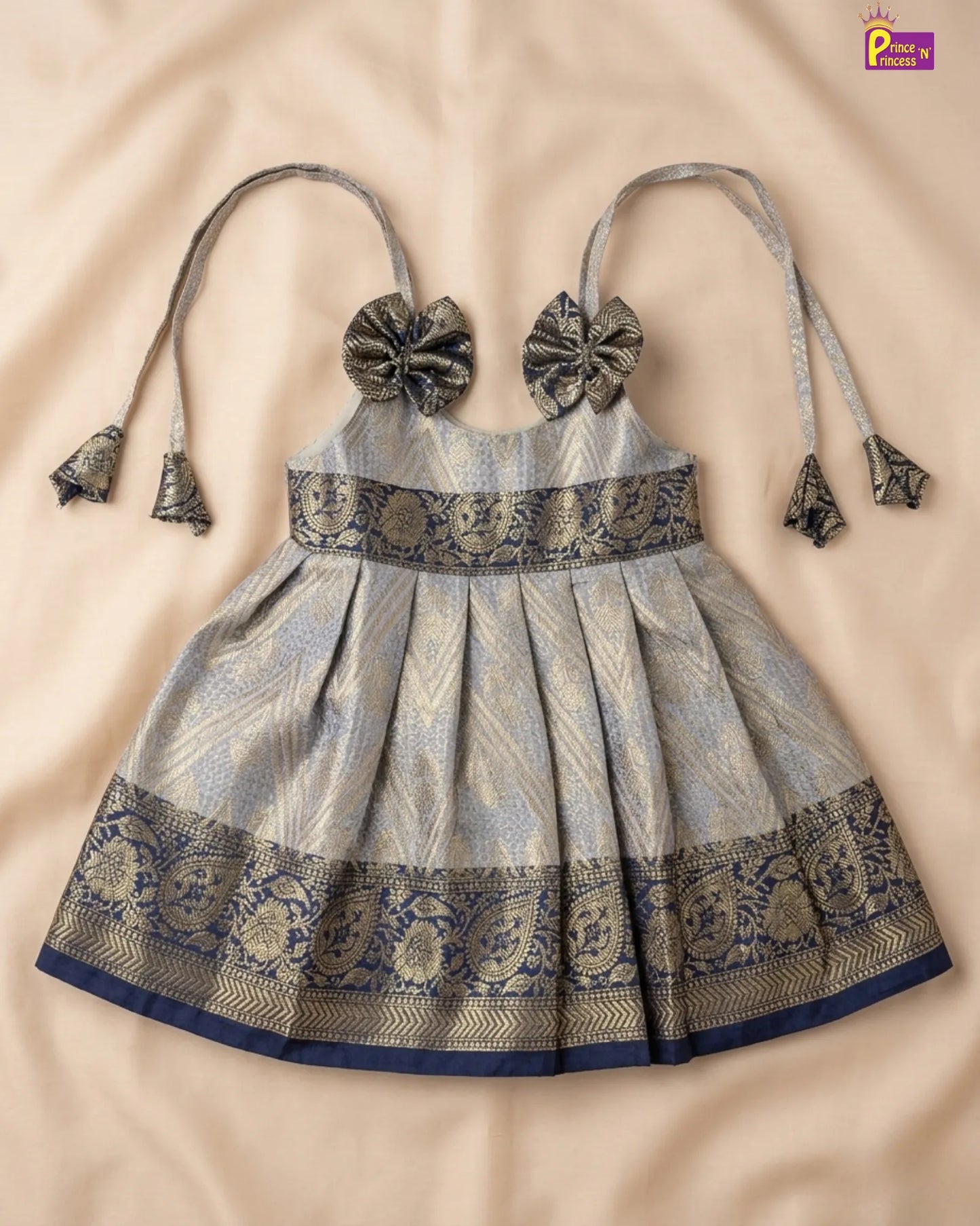 Traditional dress with intricate patterns on a beige background