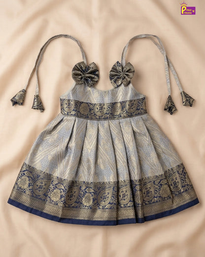 Traditional dress with intricate patterns on a beige background