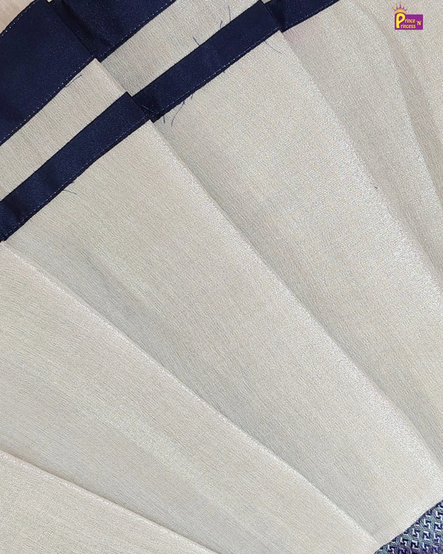 Close-up of a white fabric with a blue border