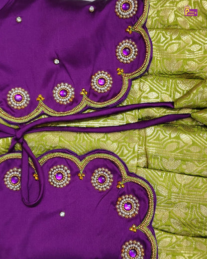 Purple and green traditional outfit with intricate embroidery