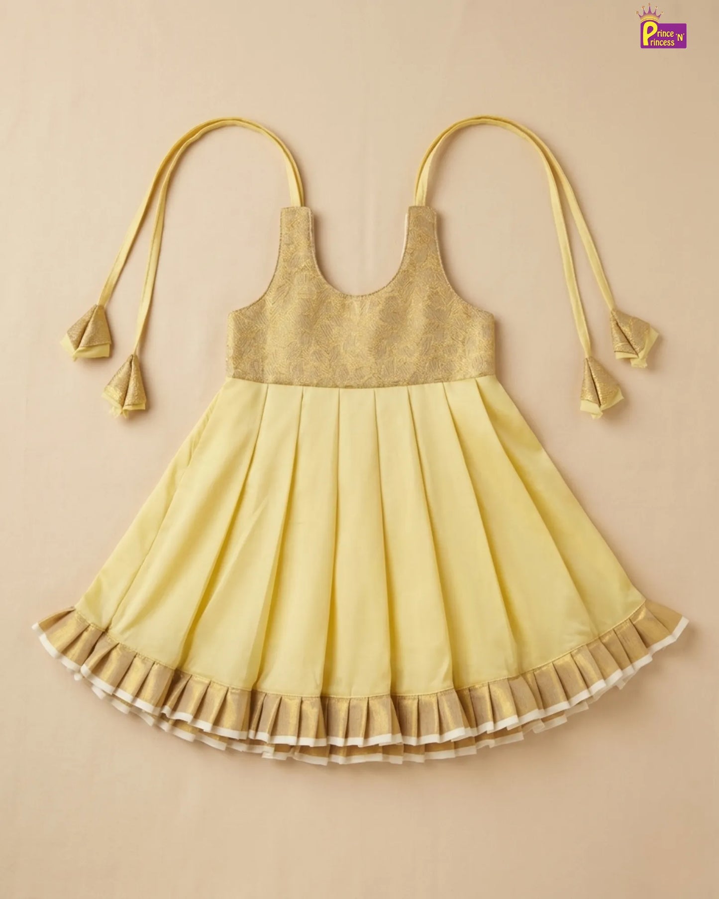 Yellow dress with pleated skirt on a beige background