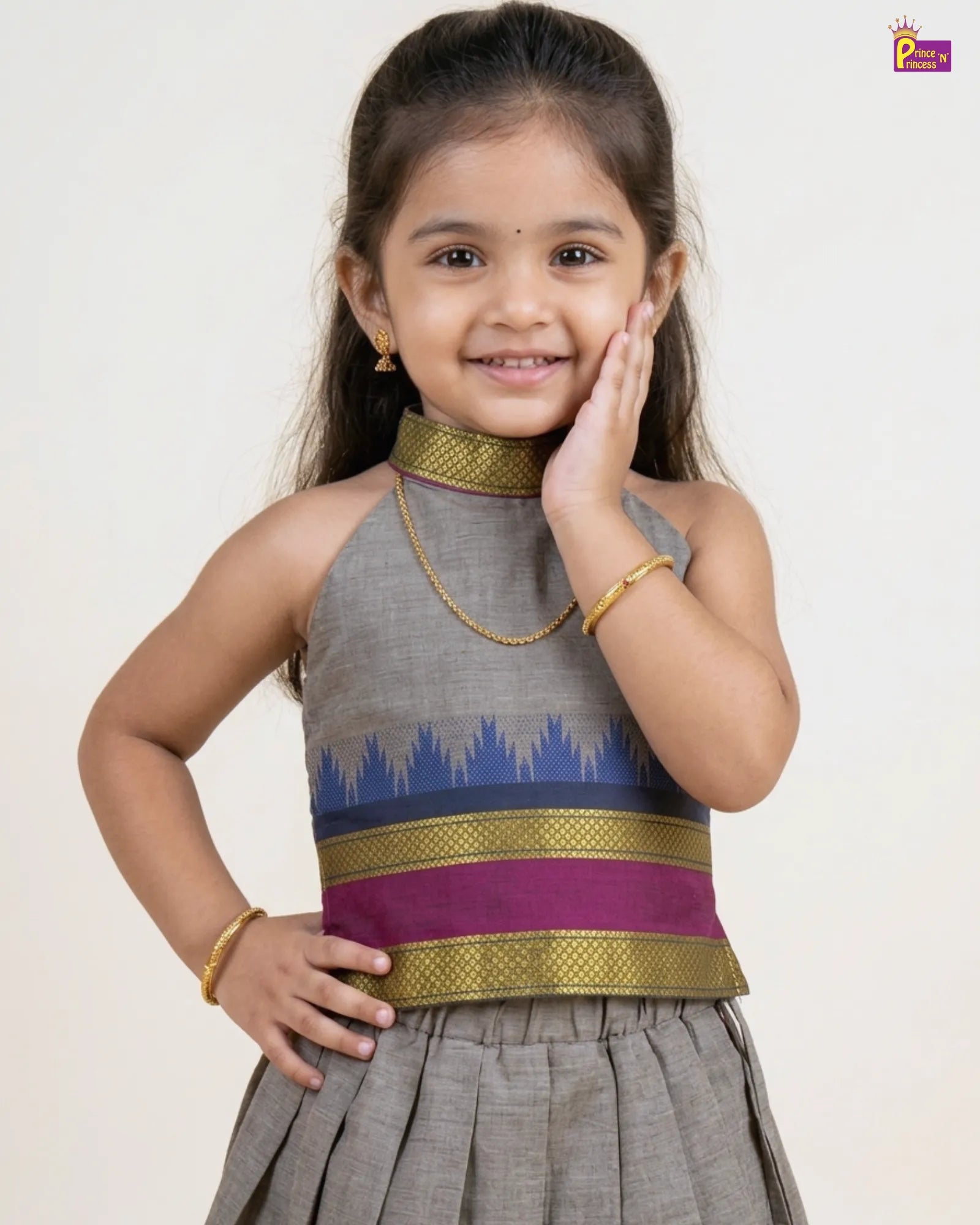 Young girl wearing a traditional outfit with a gray and purple top on a white background