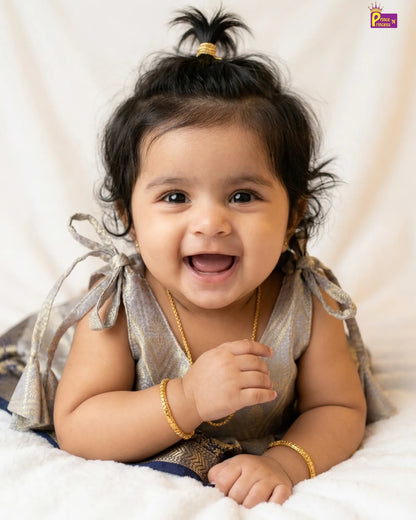 Happy baby with a gold bracelet on a white background
