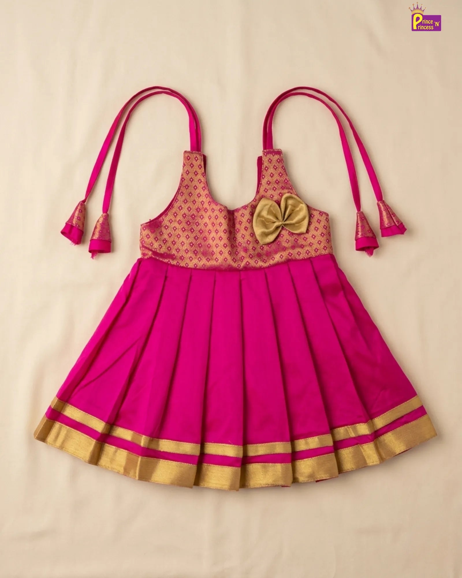 Pink traditional outfit with gold accents on a beige background