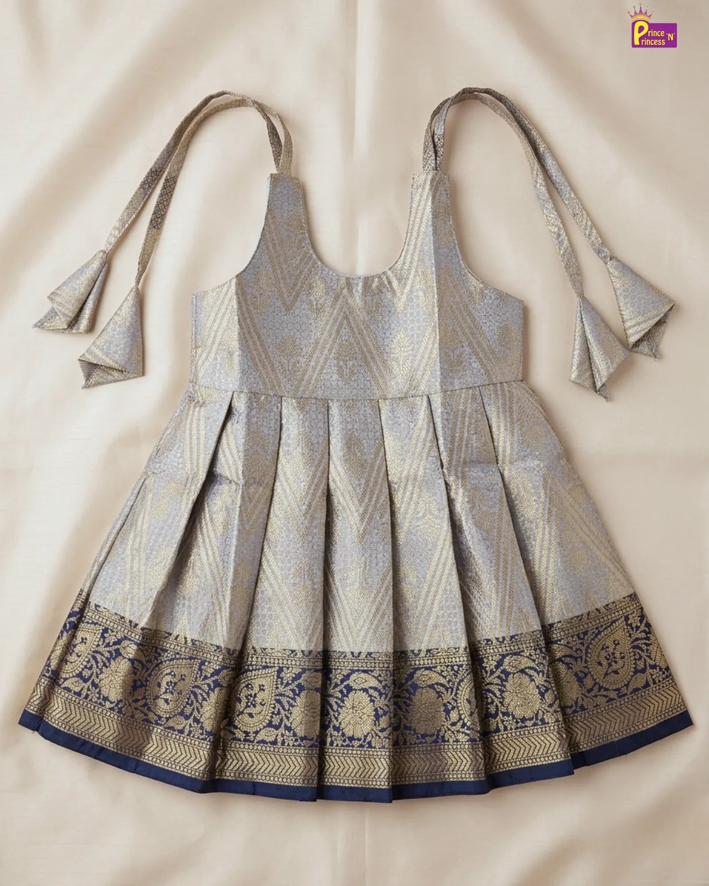 Traditional dress with intricate patterns on a beige background