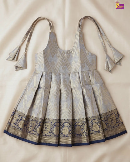 Traditional dress with intricate patterns on a beige background