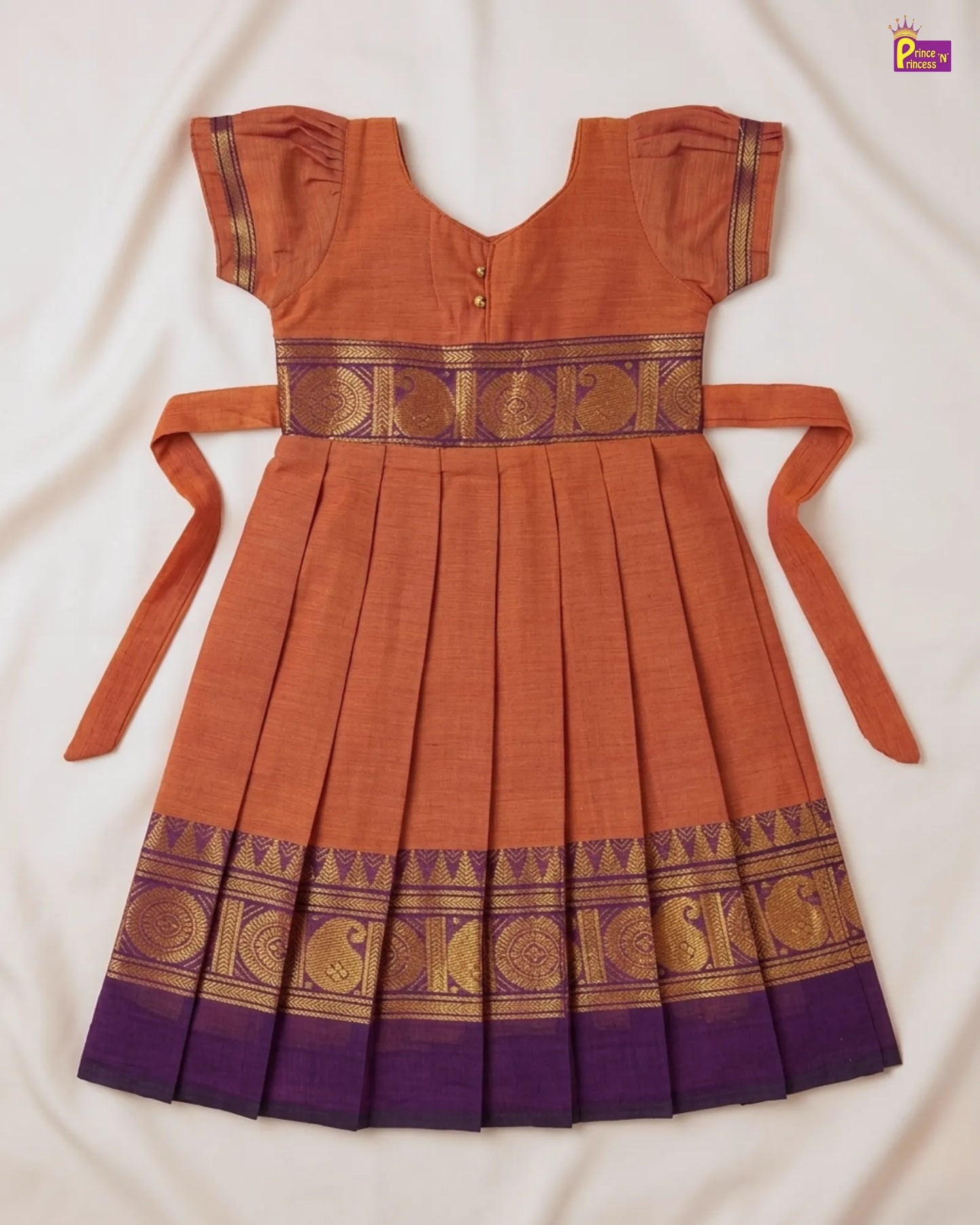 Orange and purple traditional dress with decorative patterns on a white background