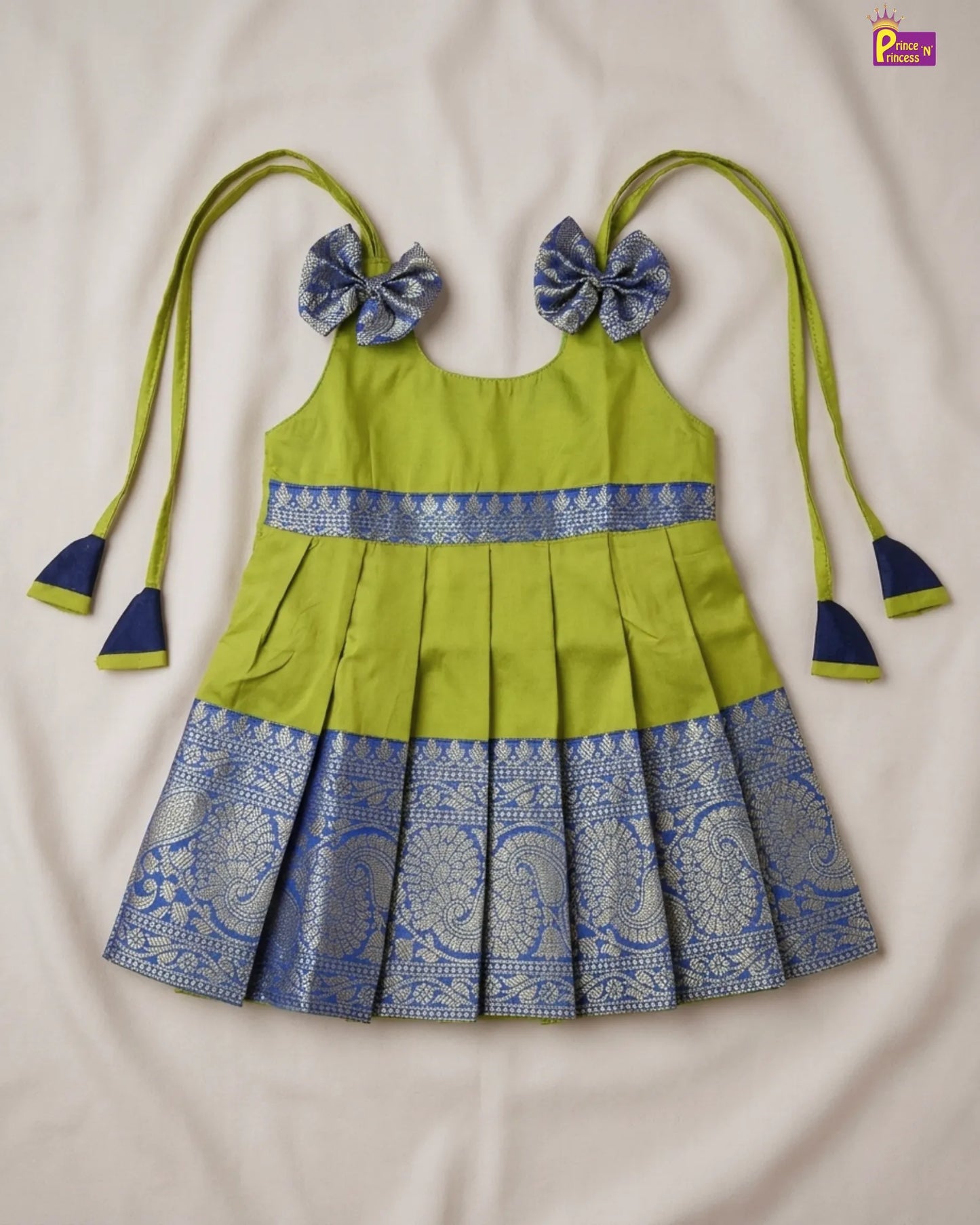 Green and blue dress with matching headbands on a light gray background