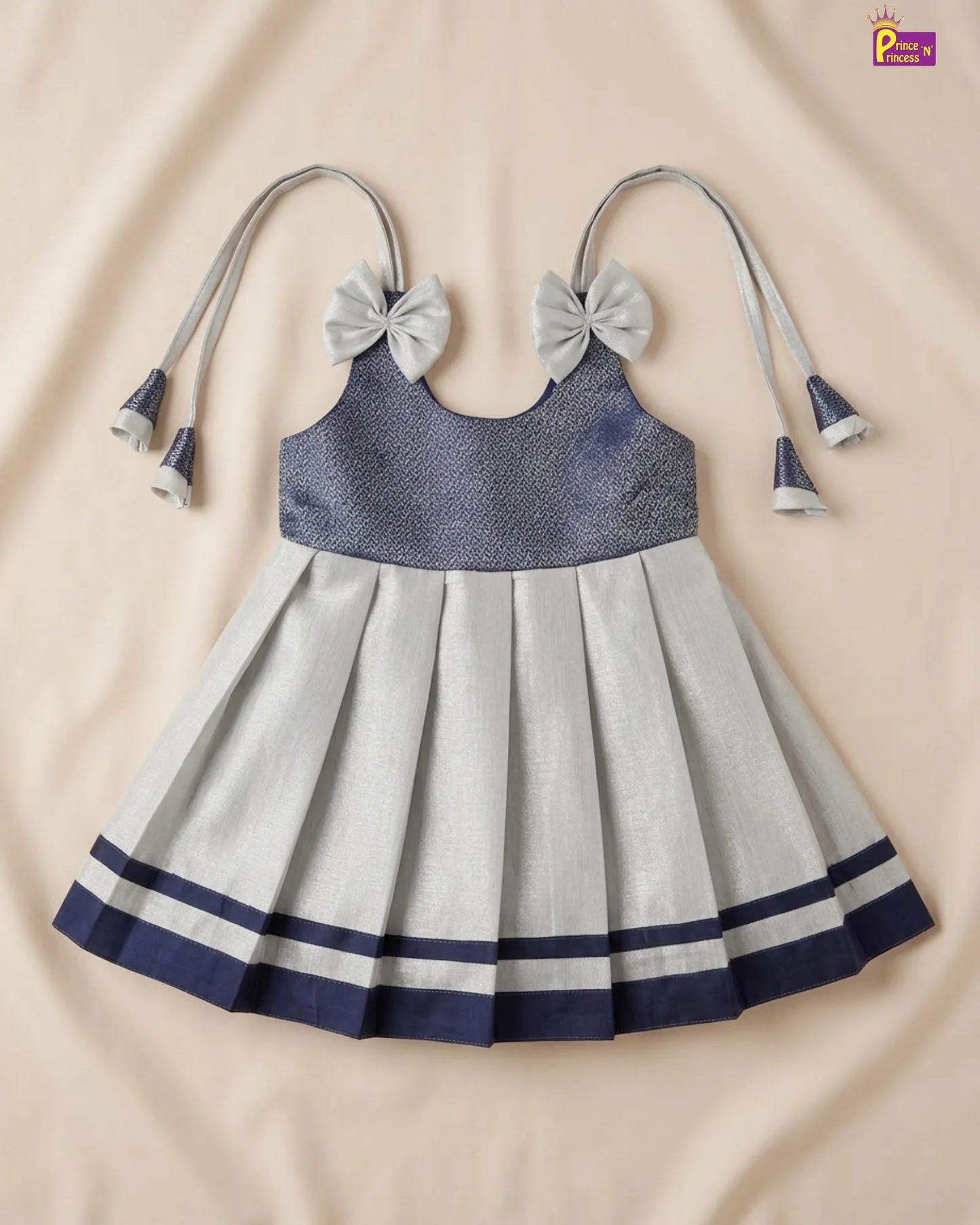 Children's dress with blue top and gray skirt on a beige background