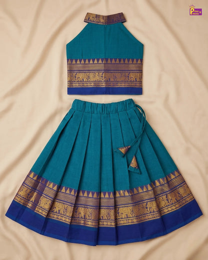 Teal traditional outfit with gold patterns on a beige fabric background
