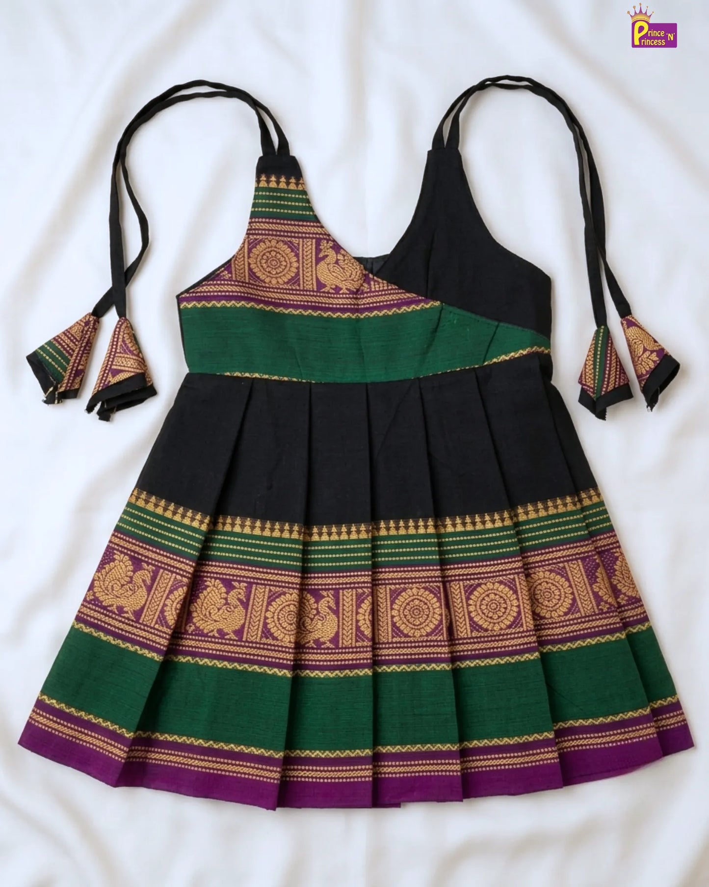 Traditional dress with green, purple, and gold patterns on a white background