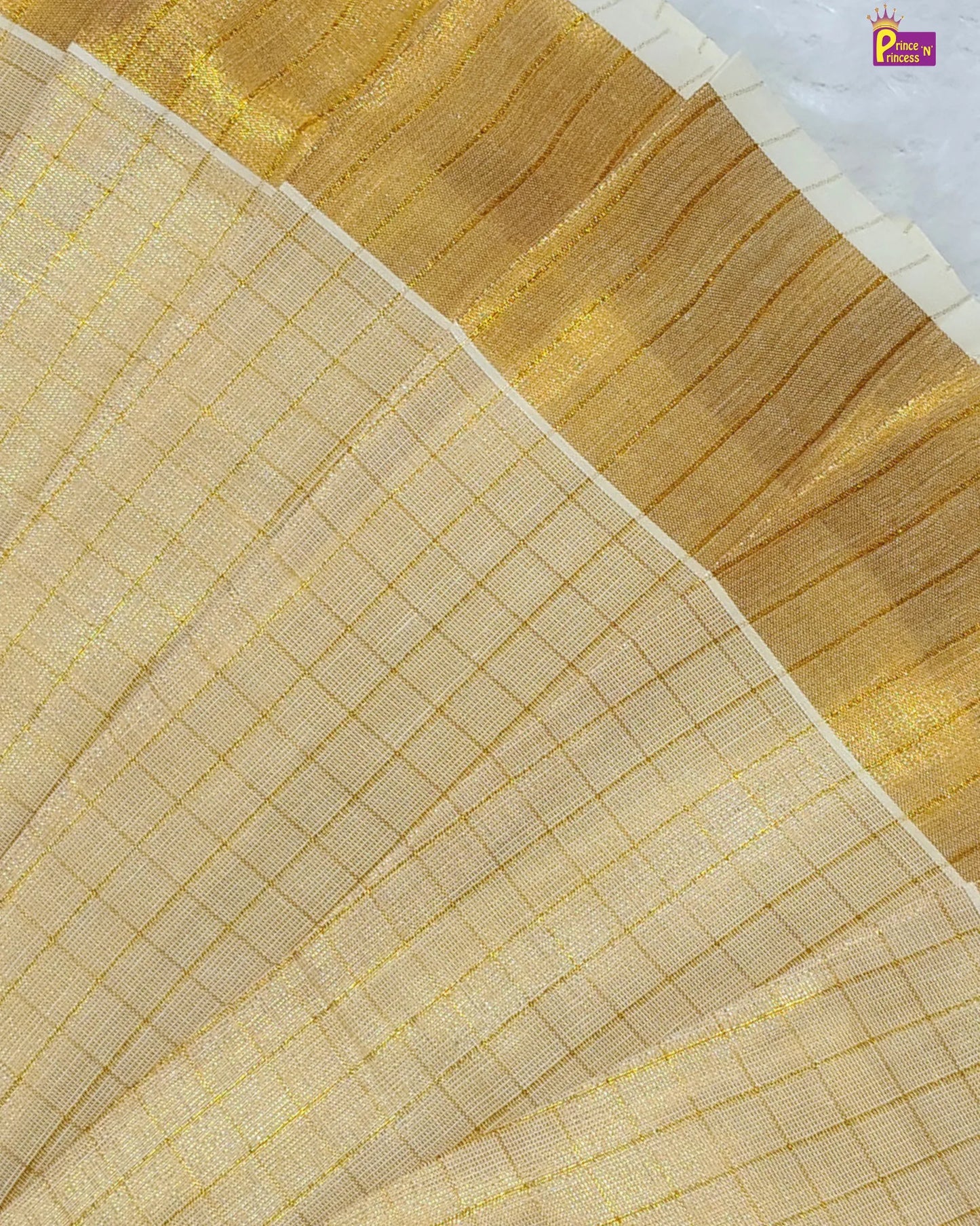 Close-up of beige fabric with gold embroidery on a white background