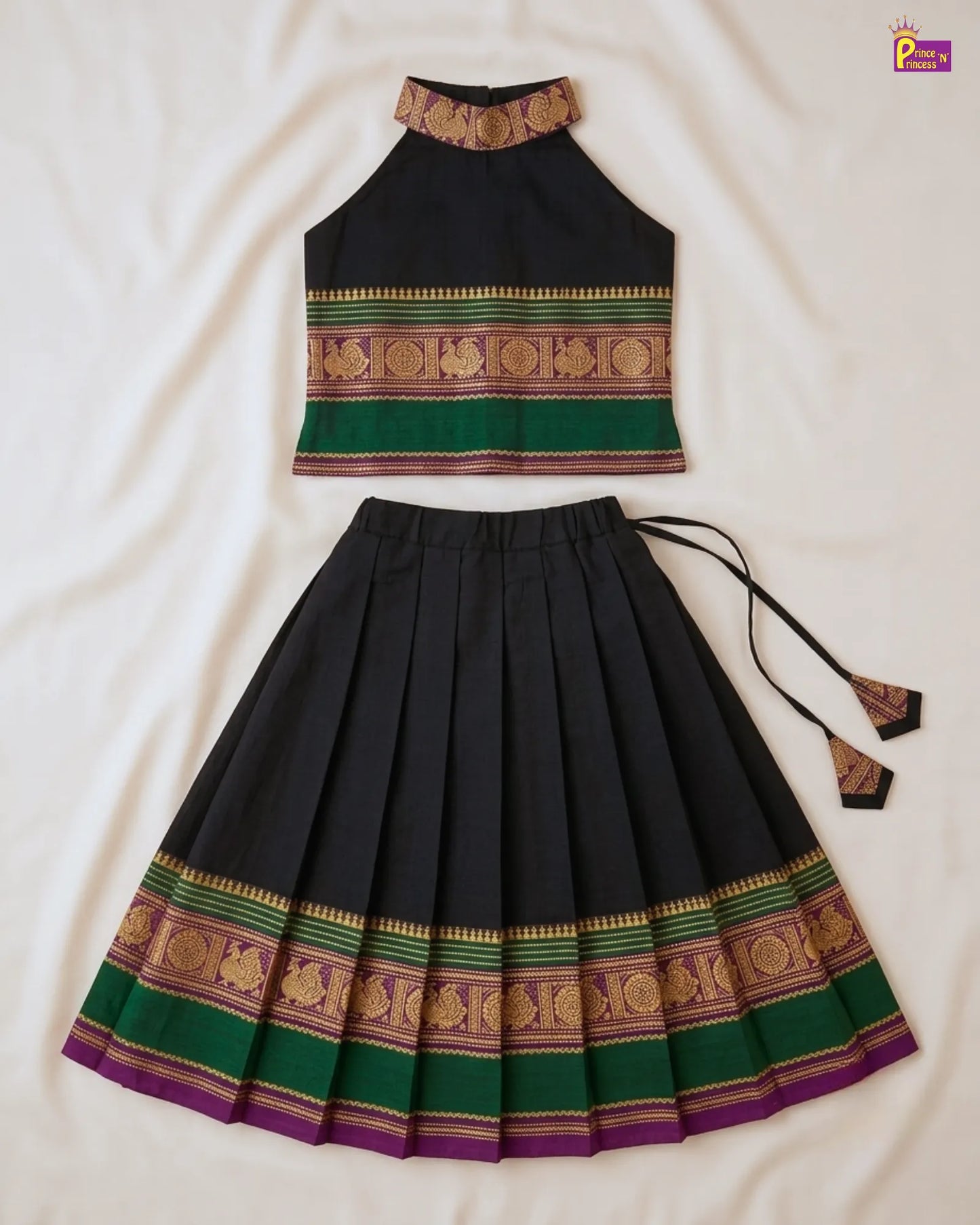 Traditional outfit with a black top and pleated skirt on a white background