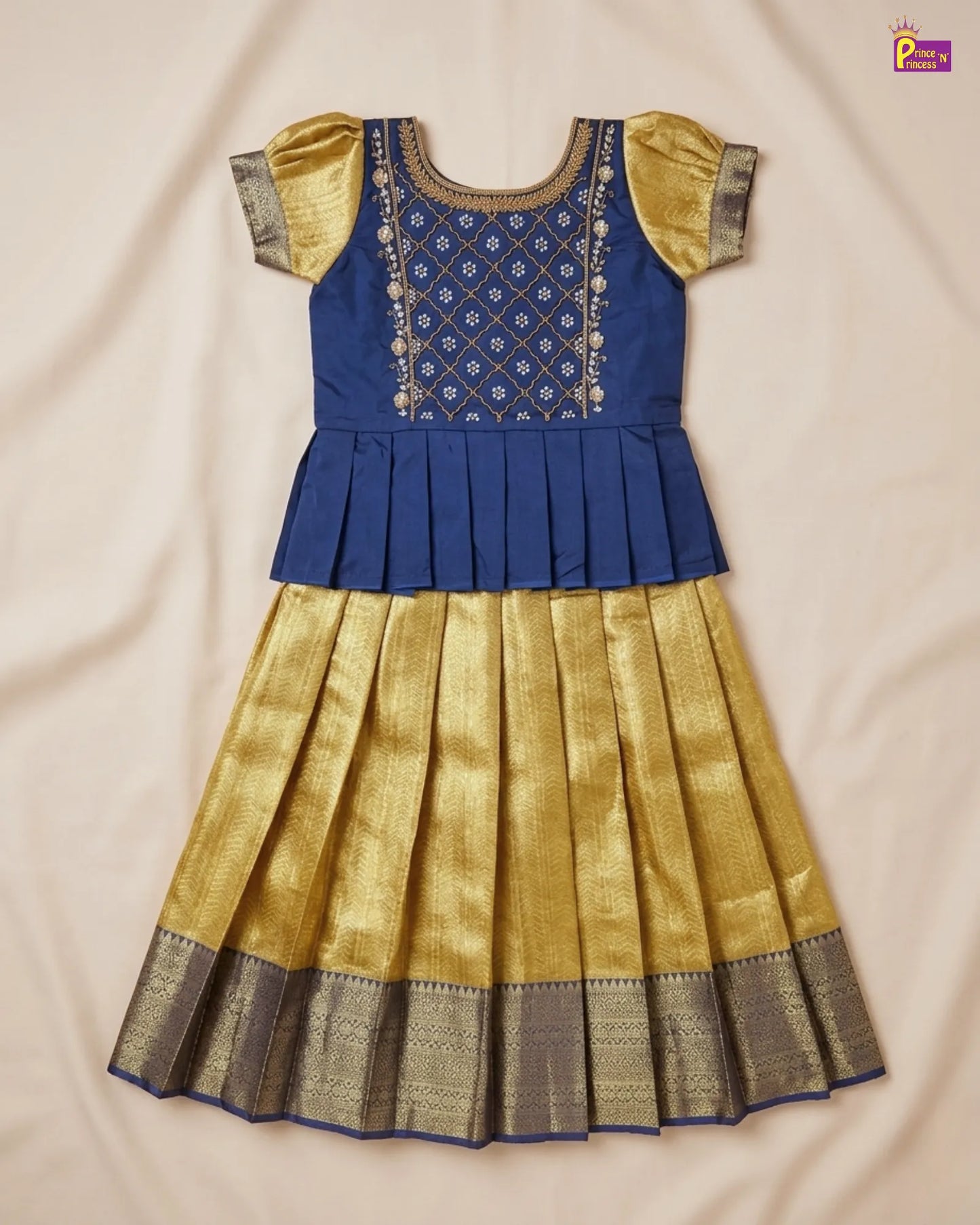 Blue and gold traditional outfit on a beige fabric background
