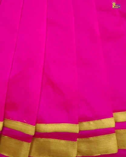 Close-up of a pink saree with gold border